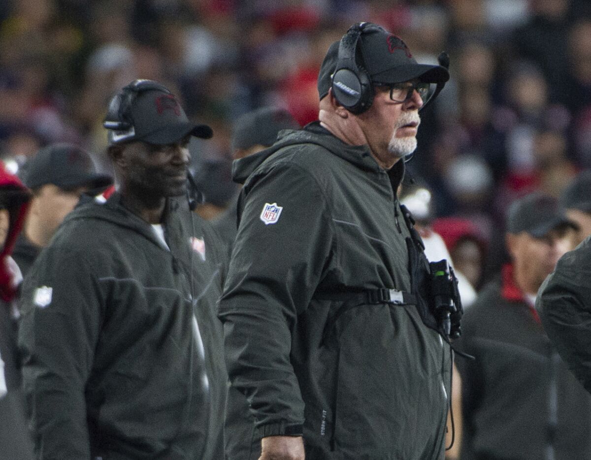 Buccaneers head coach Bruce Arians and defensive coordinator Todd Bowles (left) stand on sideline.