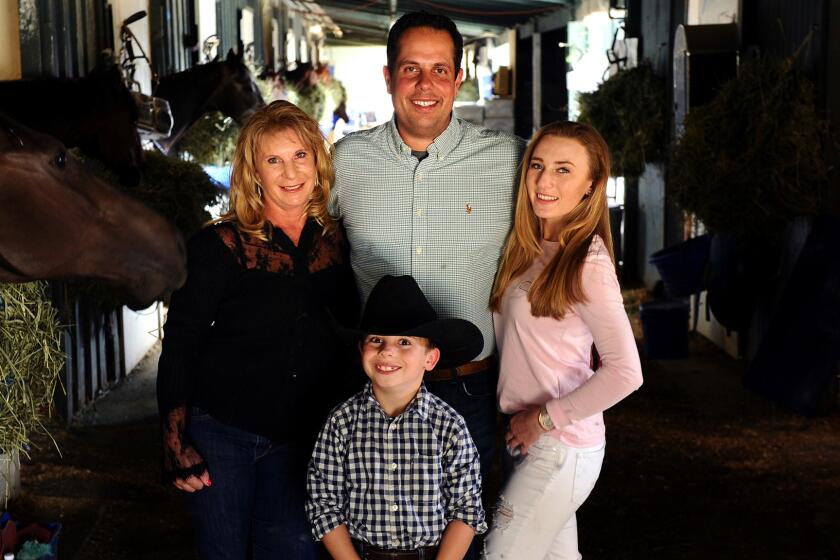 Trainer Phil D'Amato at Santa Anita with fiancee Sherri Marr, her daughter Jessica, and Ryan, the boy D'Amato and Marr are adopting.
