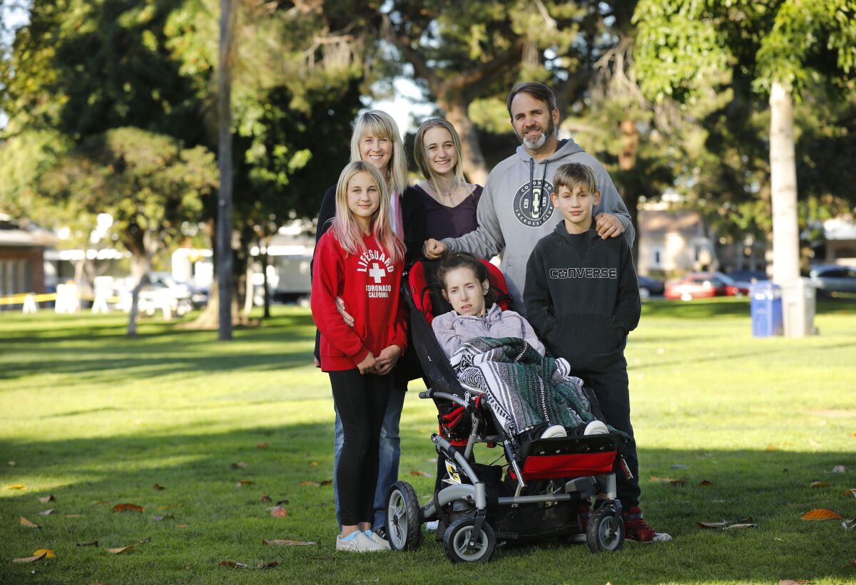 Veleria Fabiszak and her husband, Jim, have been advocating to make parks in Coronado more accessible for people with disabilities, shown here at Spreckels Park in Coronado on Dec. 17, 2019. Their daughter Chelsea has Rett syndrome, a rare non-inherited genetic postnatal neurological disorder. With them are their other children Hannah, left, Abby, and Jameson, right.