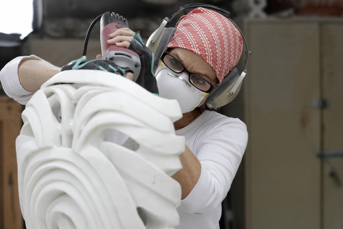Elizabeth Turk works on a project at her marble studio in Santa Ana.