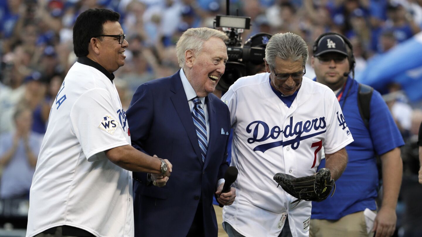 Fernando Valenzuela, Vin Scully and Steve Yeager walk off the field after the ceremonial first pitch before Game 2.
