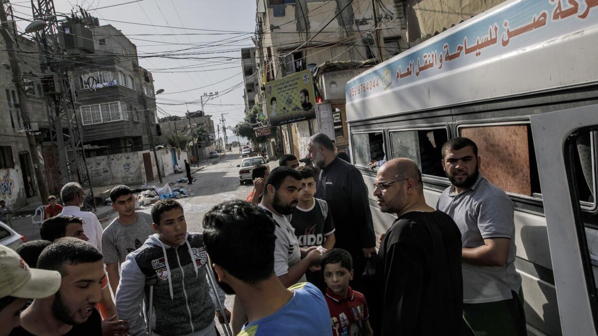 Palestinians on Friday wait to board buses to transport them to a Gaza border protest camp to break their Ramadan fast.