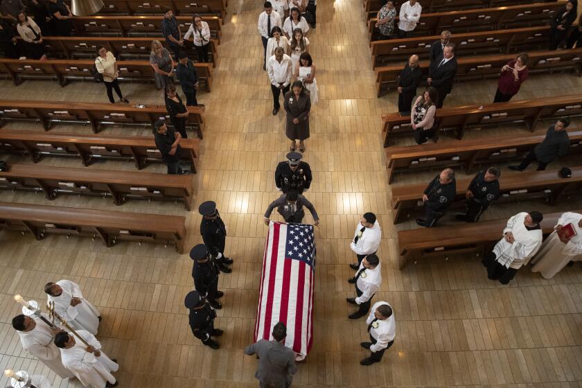 LOS ANGELES, CALIF. -- MONDAY, AUGUST 12, 2019: Pallbearers wait as an American flag is place on casket during funeral mass of slain LAPD officer Juan Diaz at the Cathedral of Our Lady of the Angels in Los Angeles, Calif., on Aug. 12, 2019. (Brian van der Brug / Los Angeles Times)