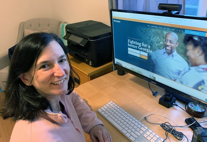 Debbie Raucher at her computer at home in Oakland, where she makes calls to try to sway the Senate runoffs in Georgia.