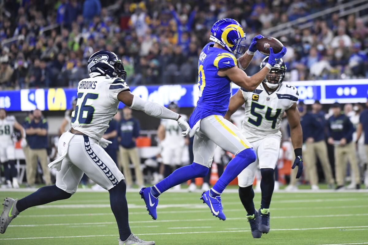 Rams receiver Cooper Kupp reaches for a pass as Seattle's Bobby Wagner (54) pursues.