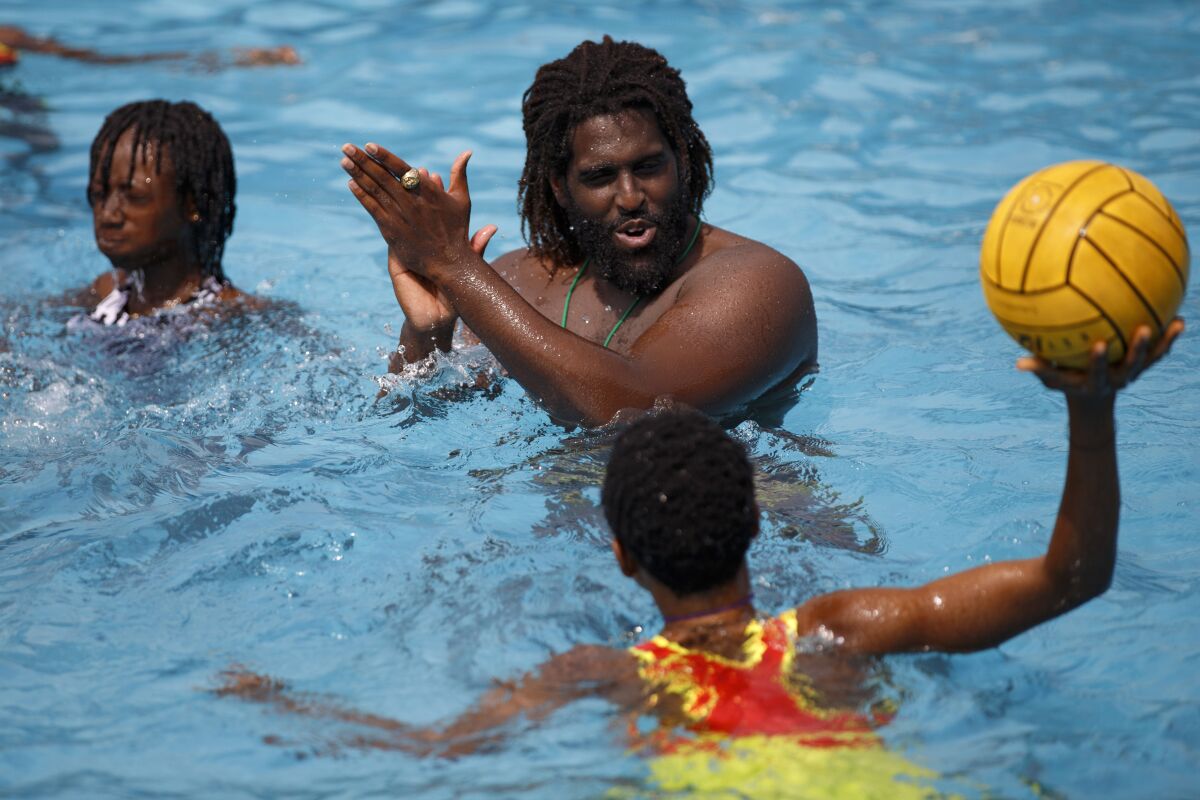 Asante Prince, the founder of Ghana's Awatu Winton Water Polo Club, oversees a training session in a swimming pool at the University of Ghana ahead of a competition in Accra, Ghana, Saturday, Jan. 14, 2023. Former water polo pro Asante Prince is training young players in the sport in his father's homeland of Ghana, where swimming pools are rare and the ocean is seen as dangerous. (AP Photo/Misper Apawu)