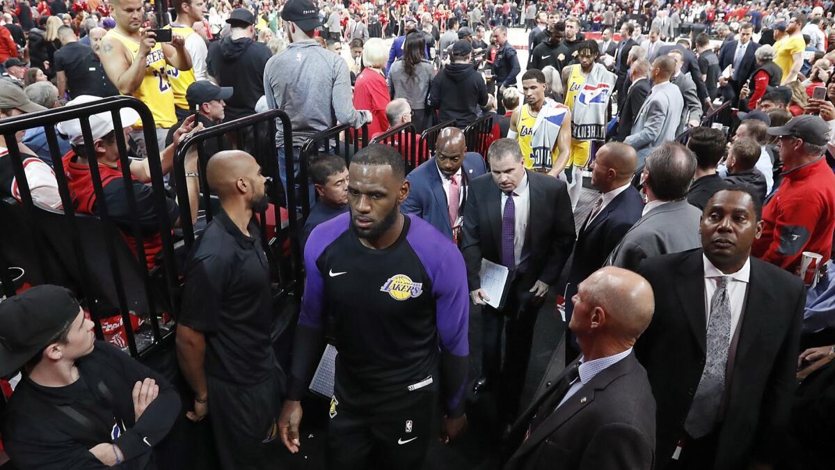 Lakers forward LeBron James heads to the locker room at halftime of the season opener in Portland.