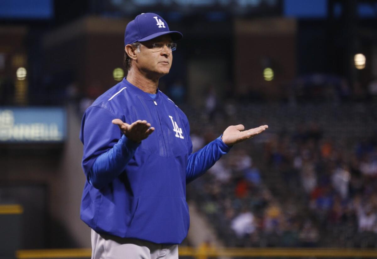 Don Mattingly gestures toward the home plate umpire during the Dodgers' game against Colorado on June 3.