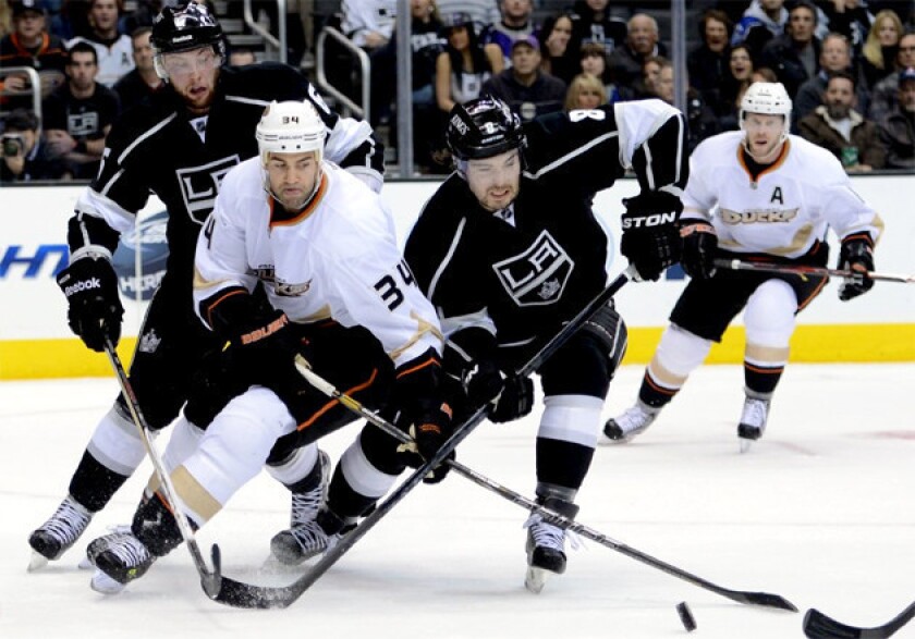Anaheim Ducks' Daniel Winnik, left, and L.A. Kings' Drew Doughty battle for the puck.