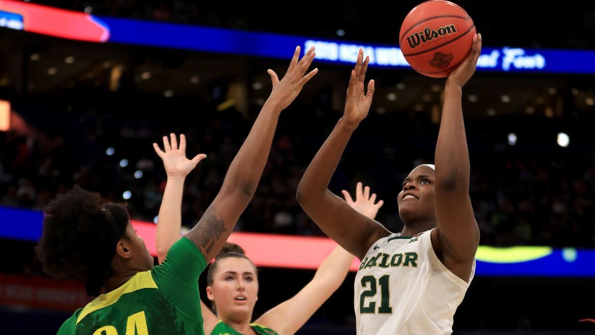 Baylor's Kalani Brown (21) attempts a shot against Oregon's Ruthy Hebard (24) and Erin Boley (21) during the fourth quarter in the semifinals of the NCAA women's Final Four on Friday in Tampa, Fla.