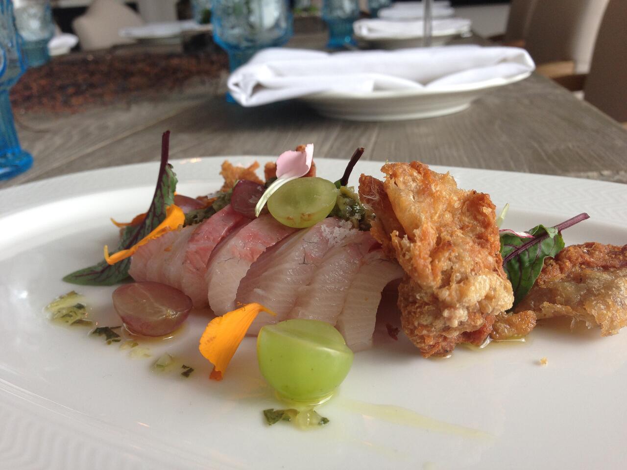 Hamachi crudo with smoked grapes, pickled serrano gribiche and crispy chicken skin.