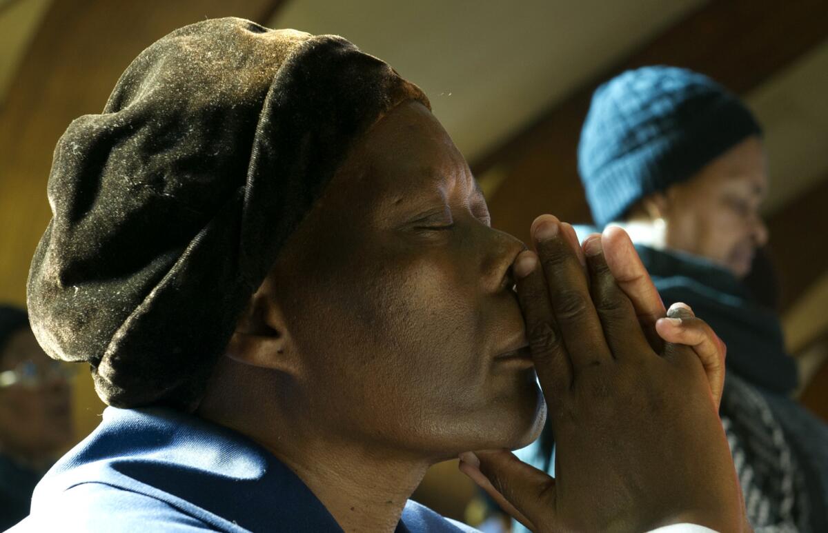 Worshipers at the Regina Mundi church in Soweto, a flash point during the anti-apartheid struggle, pray for Nelson Mandela as the ailing 94-year-old spent a second day in a hospital with a renewed lung infection.
