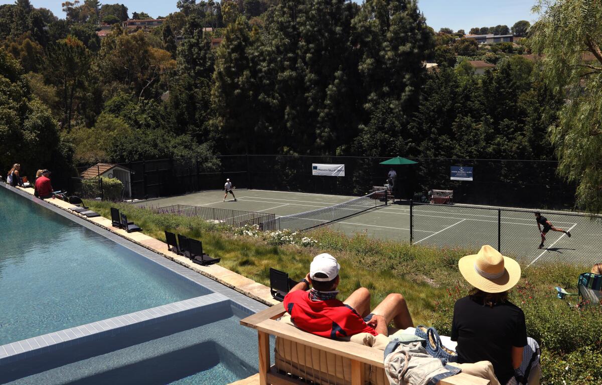 A few friends and family watch a match between Brandon Holt, left, and Marcos Giron at the Homecourt Advantage tournament in Rolling Hills on Sunday.