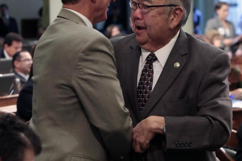 Then-Assemblyman Warren Furutani in 2012, being congratulated by then-Assemblyman Bob Wieckowski after his pension reform bill was approved by the Assembly.