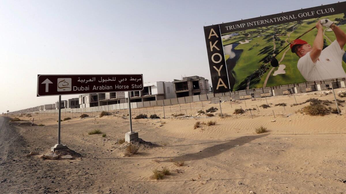 An image of Donald Trump playing golf is featured on a billboard at Trump International Golf Club Dubai, under construction in the United Arab Emirates, in 2015.