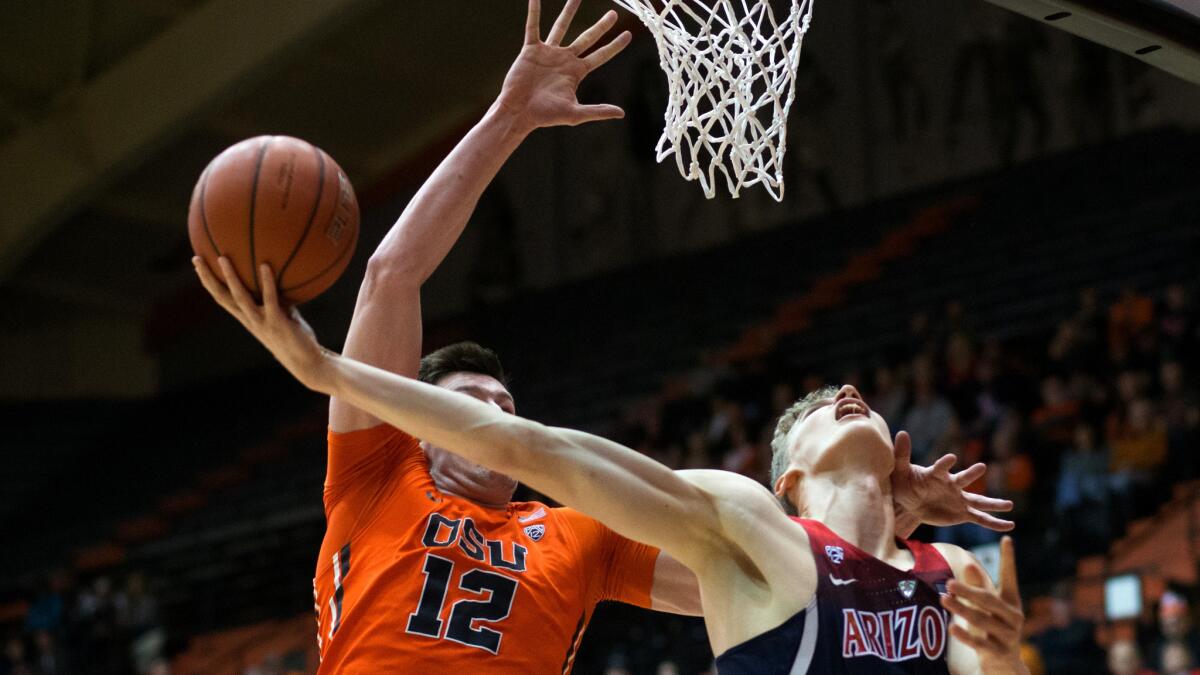 Arizona's Lauri Markkanen (10) is fouled by Oregon State's Drew Eubanks (12) during the first half Thursday night.