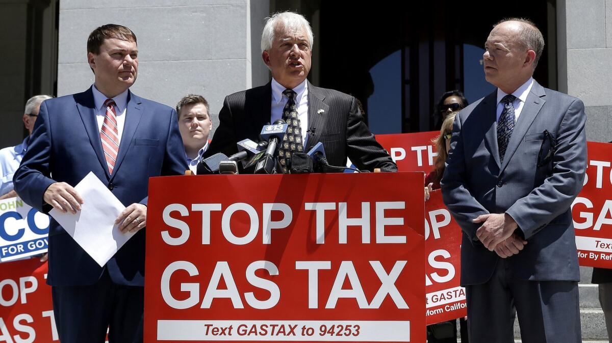 Republican gubernatorial candidate John Cox, center, blasts a recent gas tax increase during a news conference June 18 in Sacramento. Cox is flanked by Carl DeMaio, left, chairman of Reform California, and Jon Coupal, president of the Howard Jarvis Taxpayers Assn.
