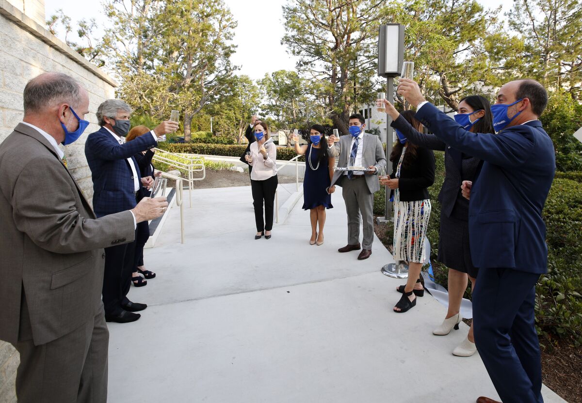 Staff and guests toast during ribbon cutting at the new UCI Health Newport Beach facility, located at Newport Center.