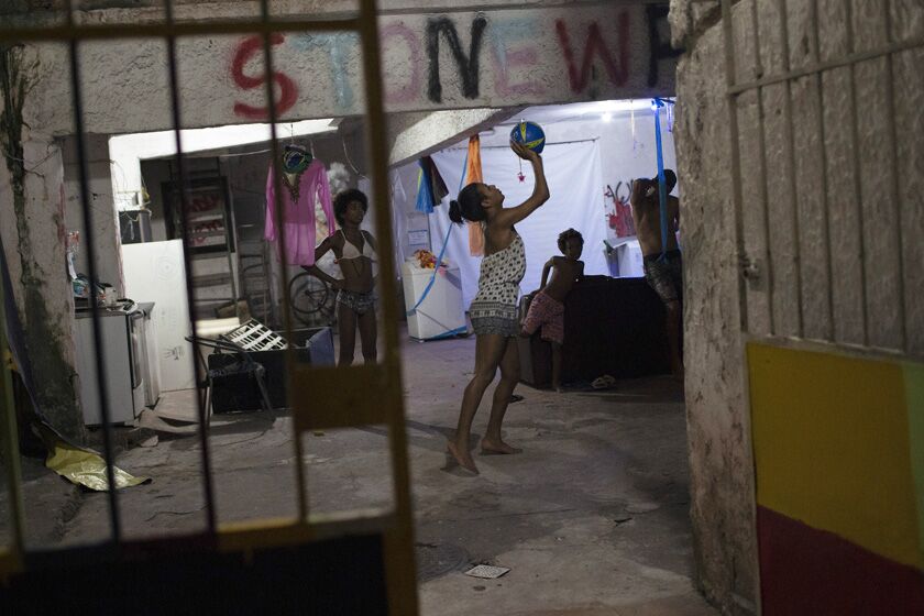 Residents play basketball at a squat known as Casa Nem in Rio de Janeiro.