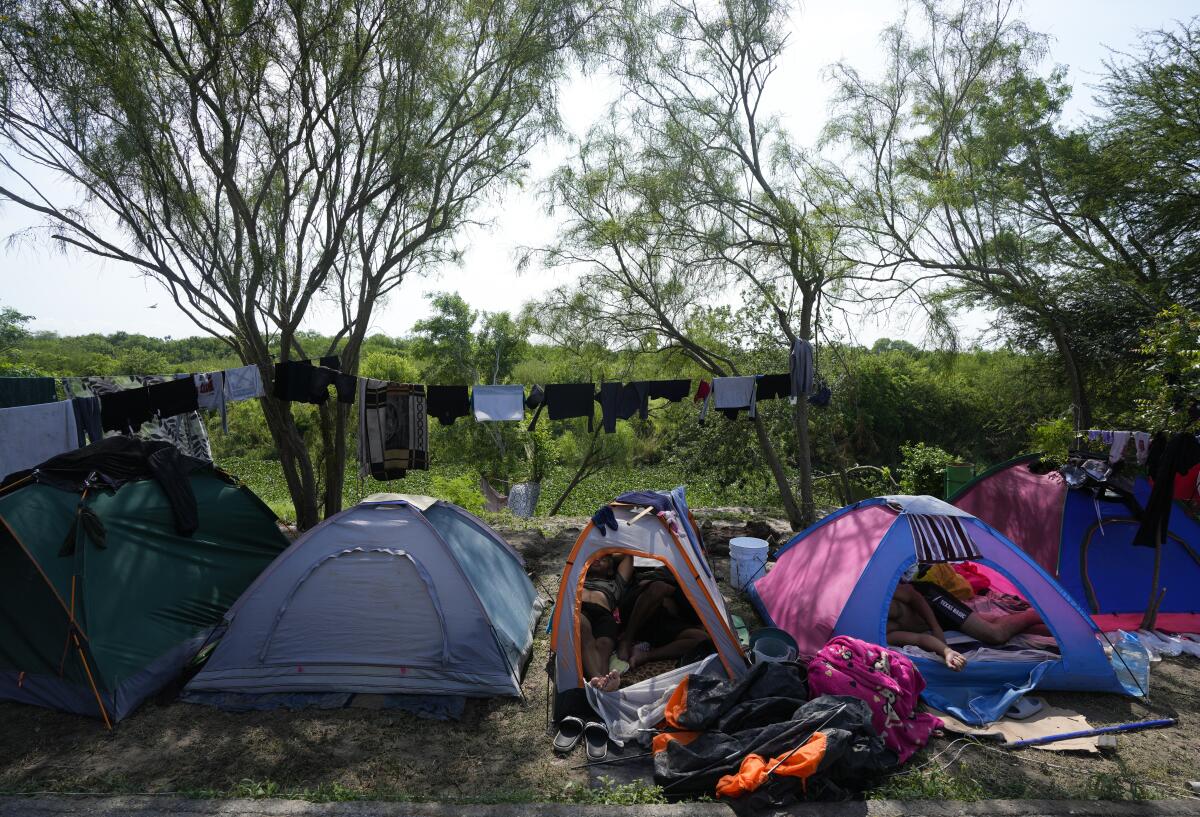 Venezuelan migrants rest inside their tents on the bank of the Rio Grande in Matamoros, Mexico