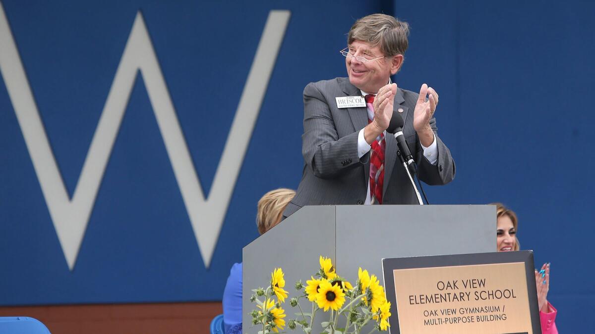 Ocean View School District board President John Briscoe applauds the completion of Oak View Elementary School's new gym during its grand opening Monday.