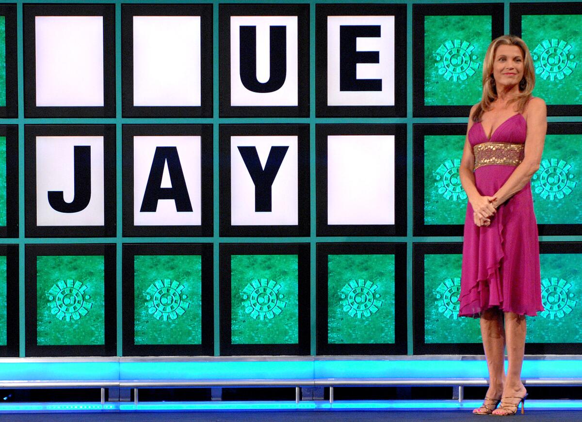 Vanna White stands in front of the letters U, E, J, A and Y on "Wheel of Fortune."