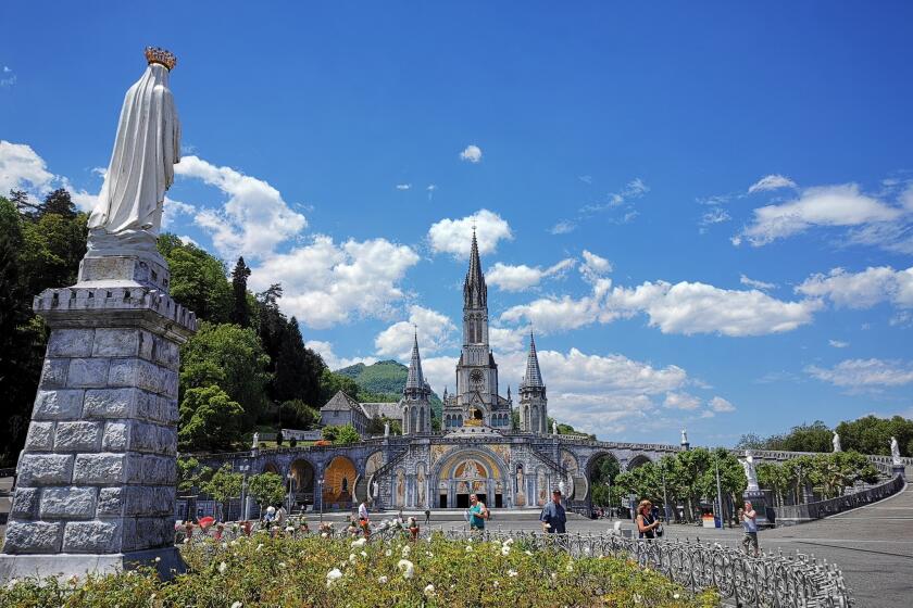 LOURDES, France ? JUNE 18, 2019: The Sanctuary of Our Lady of Lourdes (Notre Dame de Lourdes) is the centerpiece of the city and features a soaring Gothic cathedral built over the grotto where Bernadette had her visions.