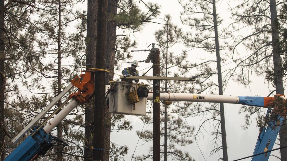 PG&E crews work to reinstall utility poles in Concow, Calif. on Nov. 16, 2018.