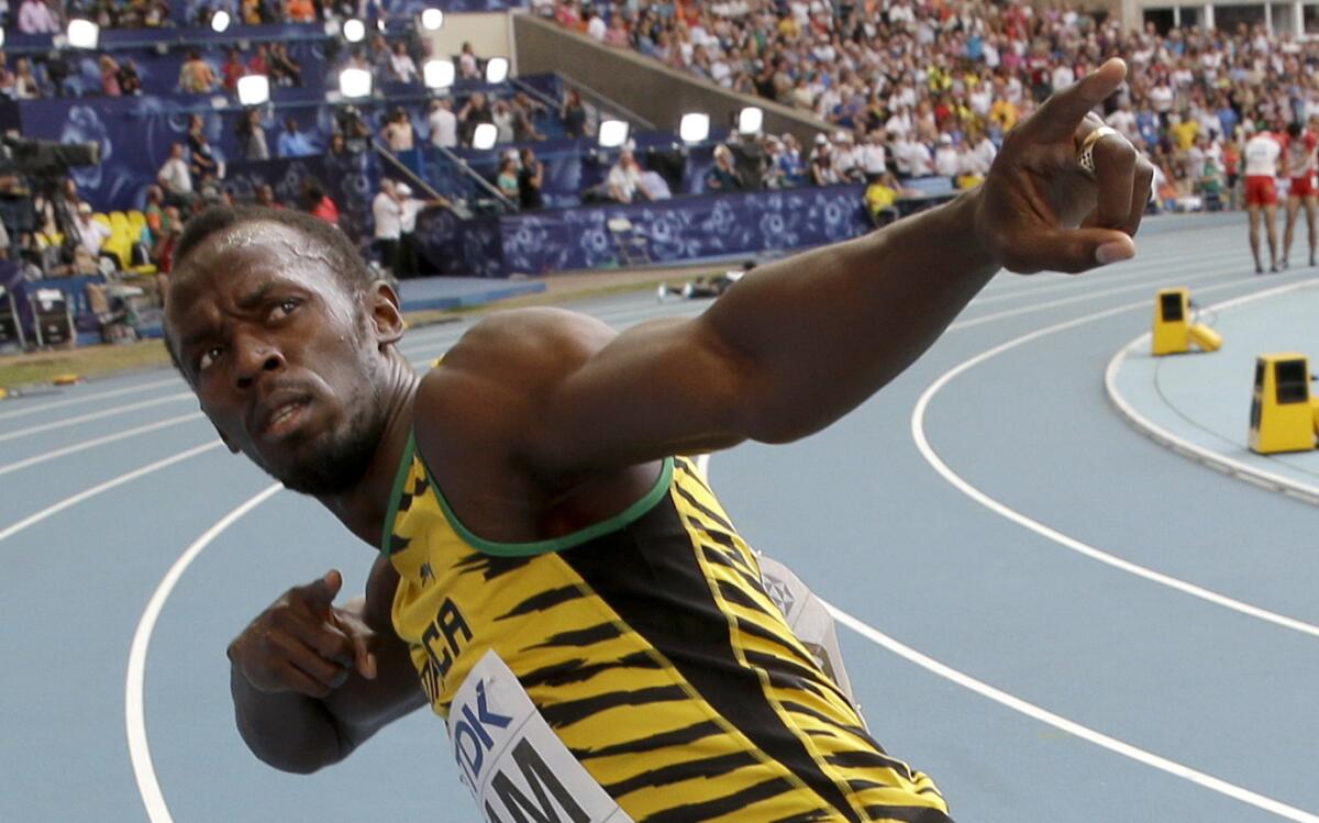 Jamaica's Usain Bolt celebrates winning his third gold medal in the men's 400-meter relay at the World Athletics Championships on Aug. 18, 2013.