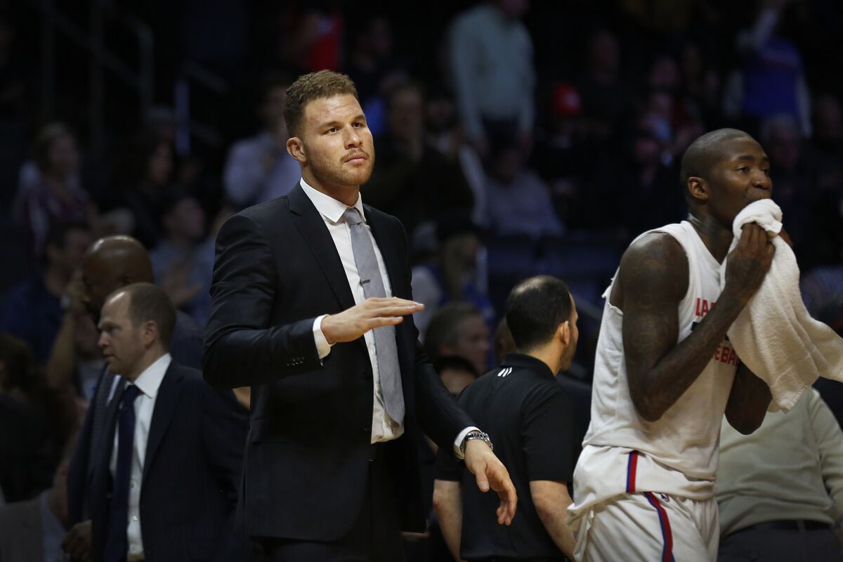 Clippers forward Blake Griffin looks on from the bench during a game against the Miami Heat on Jan. 13.