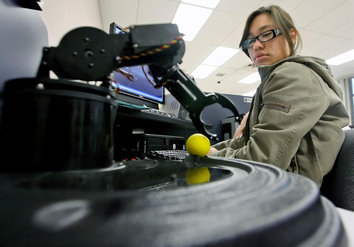 A Luther Burbank Middle School student uses a computer to control a robotic arm during a "Exploring Techonology" lab in 2010. Burbank educators are hoping to take advantage of a $110-million bond passed last year to amp schools up with more advanced technology in classrooms.