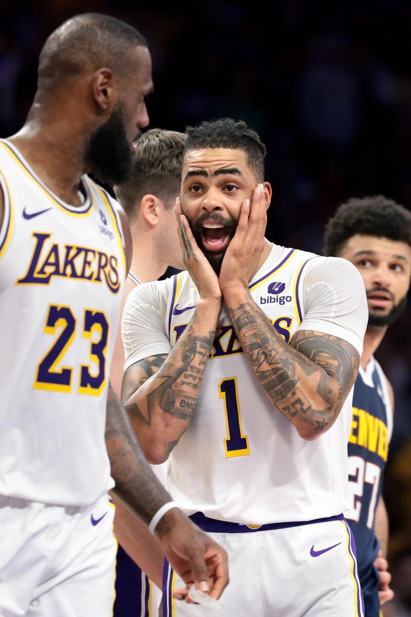 Lakers guard D'Angelo Russell gestures while talking with LeBron James during Game 4.