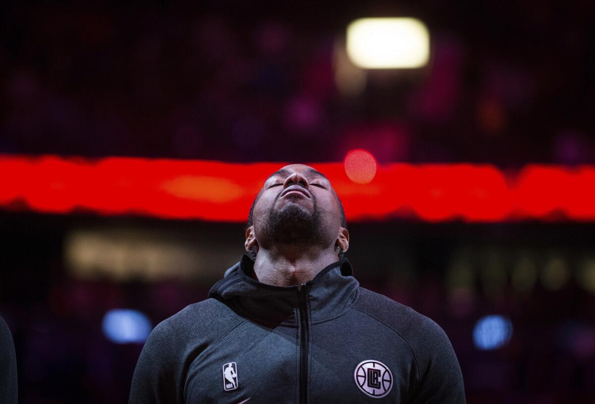 Los Angeles Clippers' Kawhi Leonard stands during the national anthems before the team's NBA preseason basketball game against the Dallas Mavericks on Thursday, Oct. 17, 2019, in Vancouver, British Columbia. (Darryl Dyck/The Canadian Press via AP)
