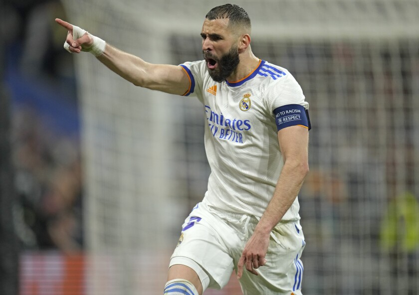 Real Madrid's Karim Benzema celebrates after scoring his side's third goal during the Champions League semi final, second leg soccer match between Real Madrid and Manchester City at the Santiago Bernabeu stadium in Madrid, Spain, Wednesday, May 4, 2022. (AP Photo/Manu Fernandez)