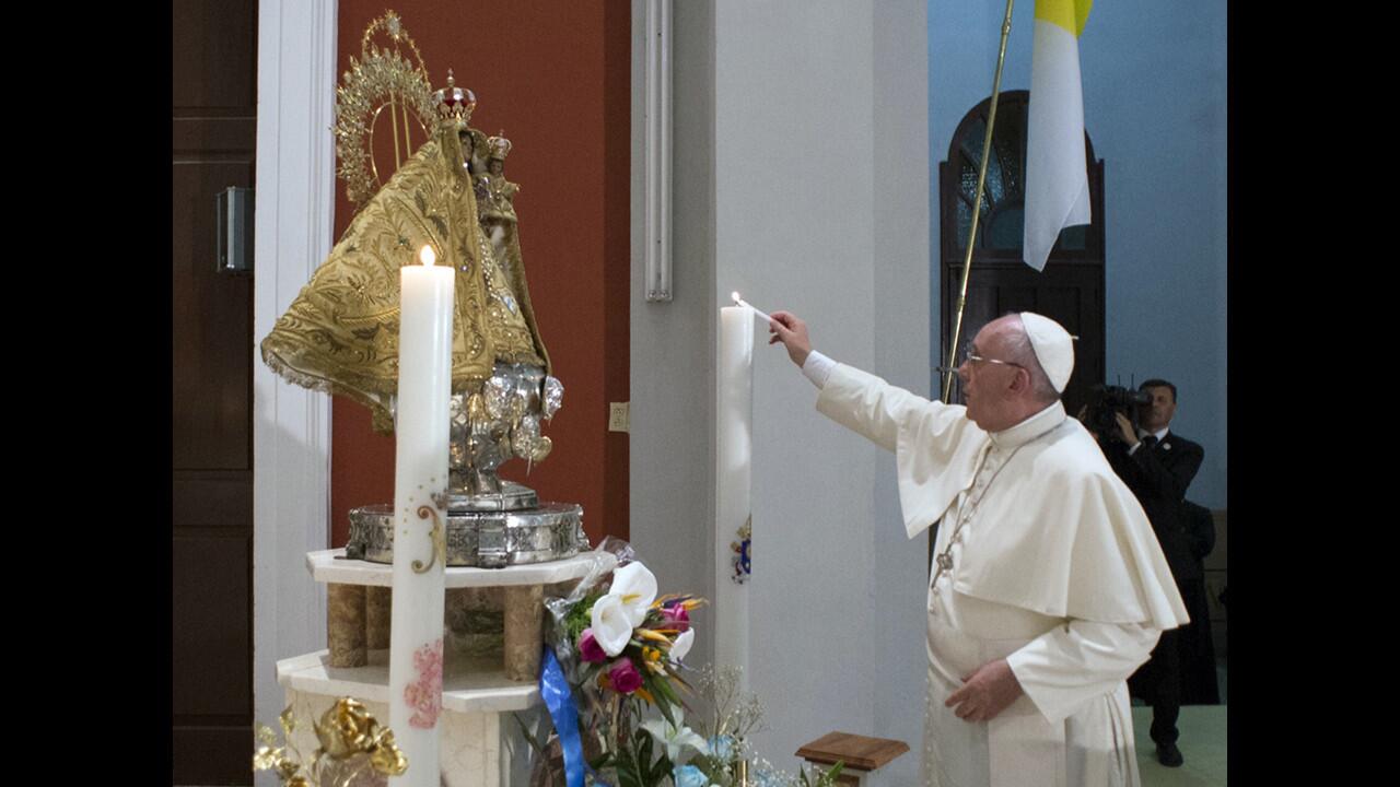 Pope Francis lights a candle during a prayer at the Sanctuary of the Virgin of Charity of El Cobre in Santiago, Cuba, on Sept. 22.