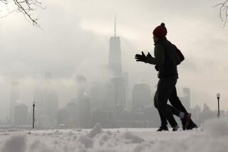 HOBOKEN, NJ - FEBRUARY 17: People run in a snow-covered park in front of the skyline of lower Manhattan and One World Trade Center in New York City on February 17, 2024, in Hoboken, New Jersey. (Photo by Gary Hershorn/Getty Images)