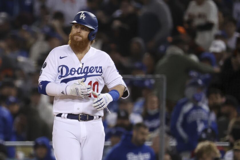 Los Angeles, CA - October 11: Los Angeles Dodgers' Justin Turner walks off first after flying out.