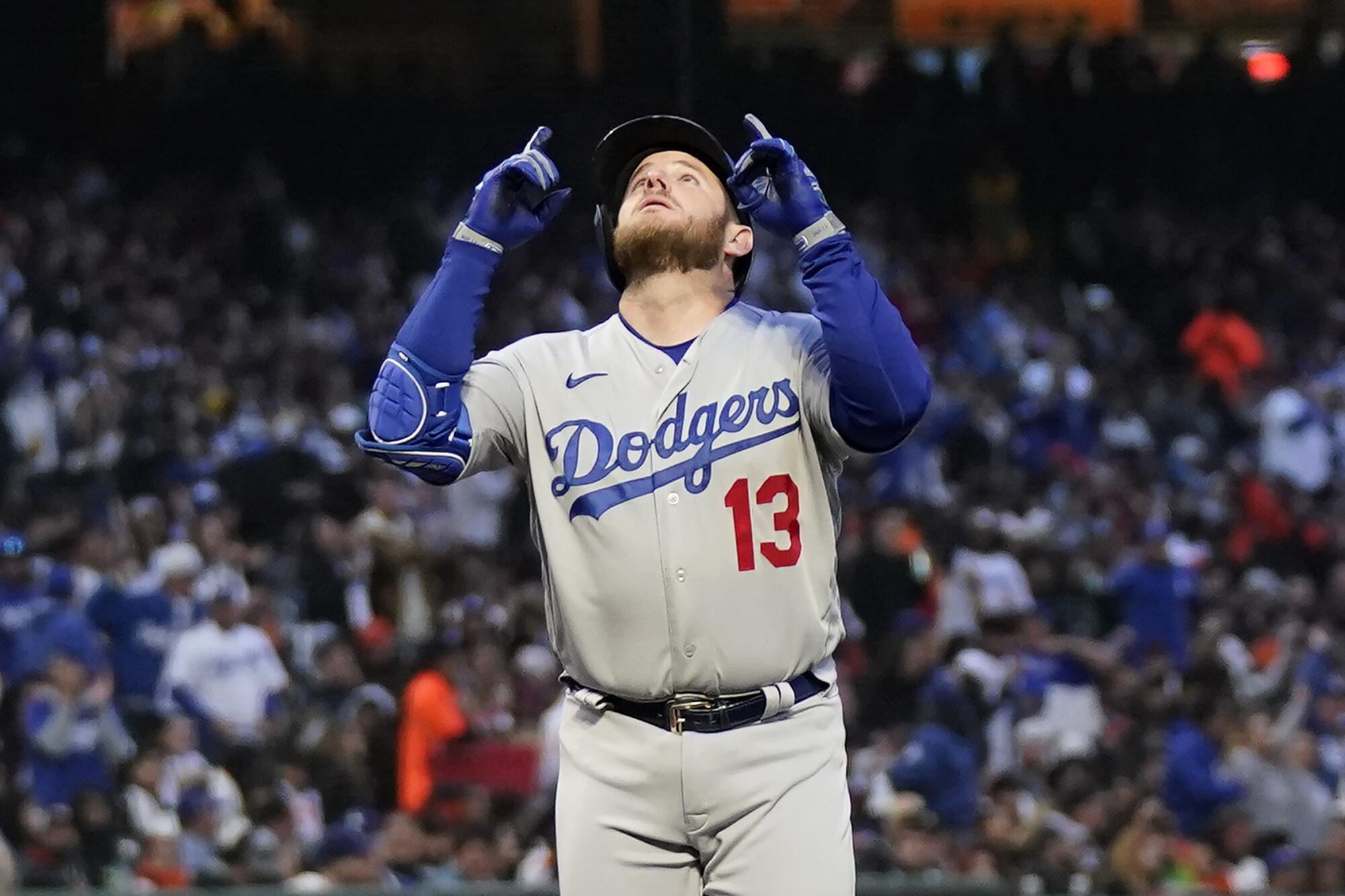 Max Muncy gestures after hitting a three-run home run in the third inning.