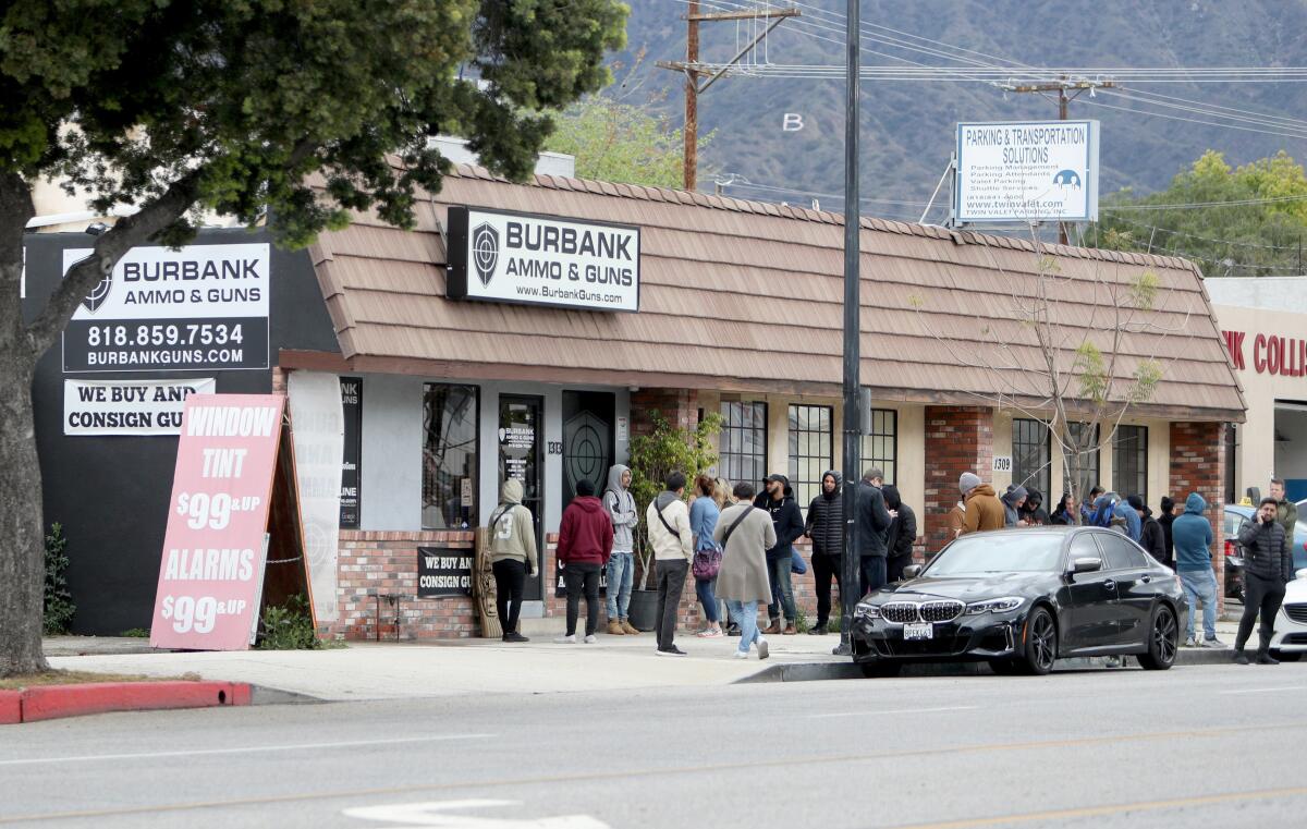 Customers line up outside Burbank Ammo & Guns on Magnolia Ave. in Burbank on March 17, 2020.