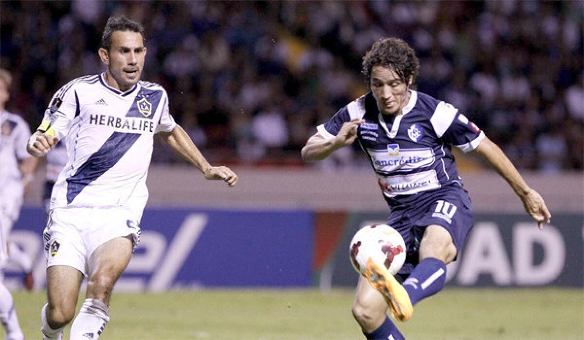 Randall Brenes of Cartagines tries to keep the ball from the Galaxy's Pablo Mastroeni during L.A.'s 3-0 victory over the Costa Rican team on Sept. 25, 2013.