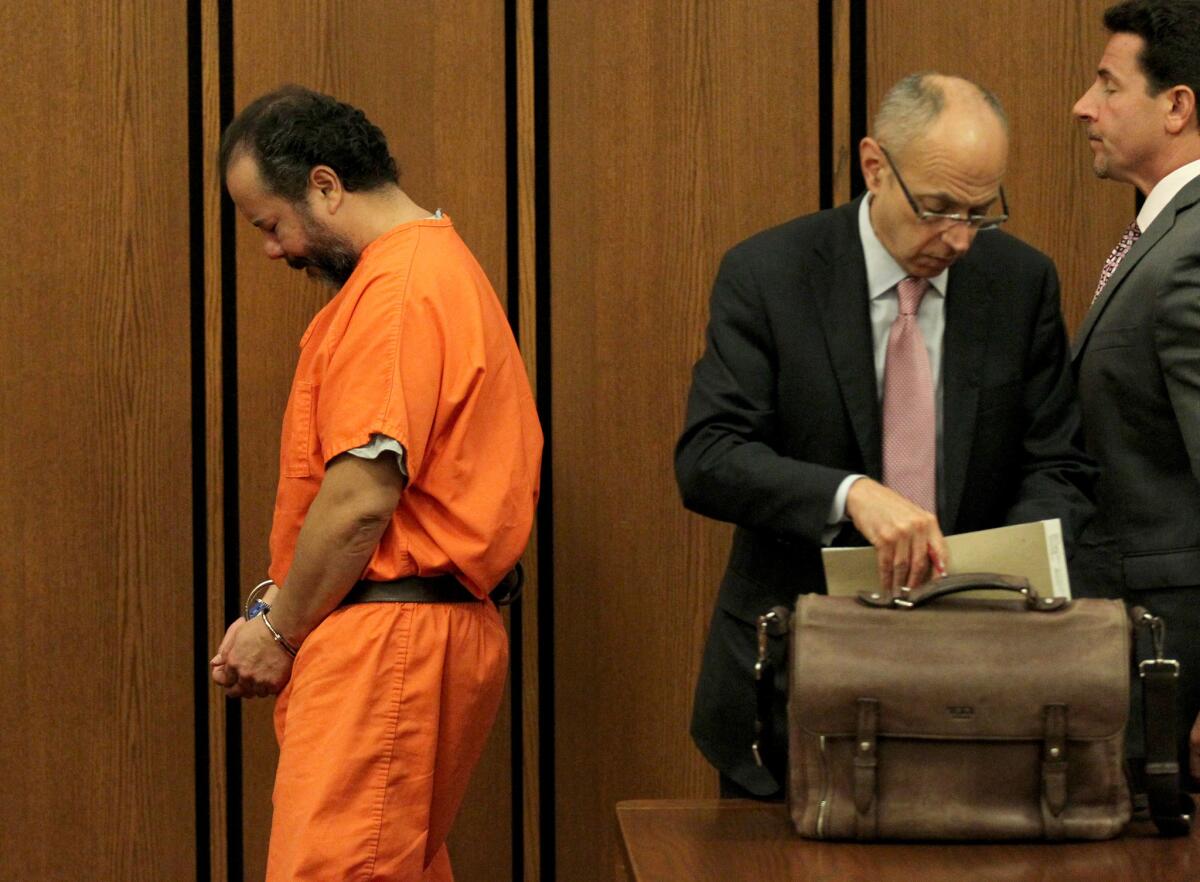 Ariel Castro walks past his attorneys Jaye Schlachet, center, and Craig Weintraub after his second pre-trial hearing two weeks ago.