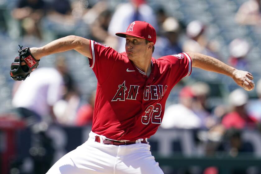 Los Angeles Angels starting pitcher Tucker Davidson throws to a Minnesota Twins.