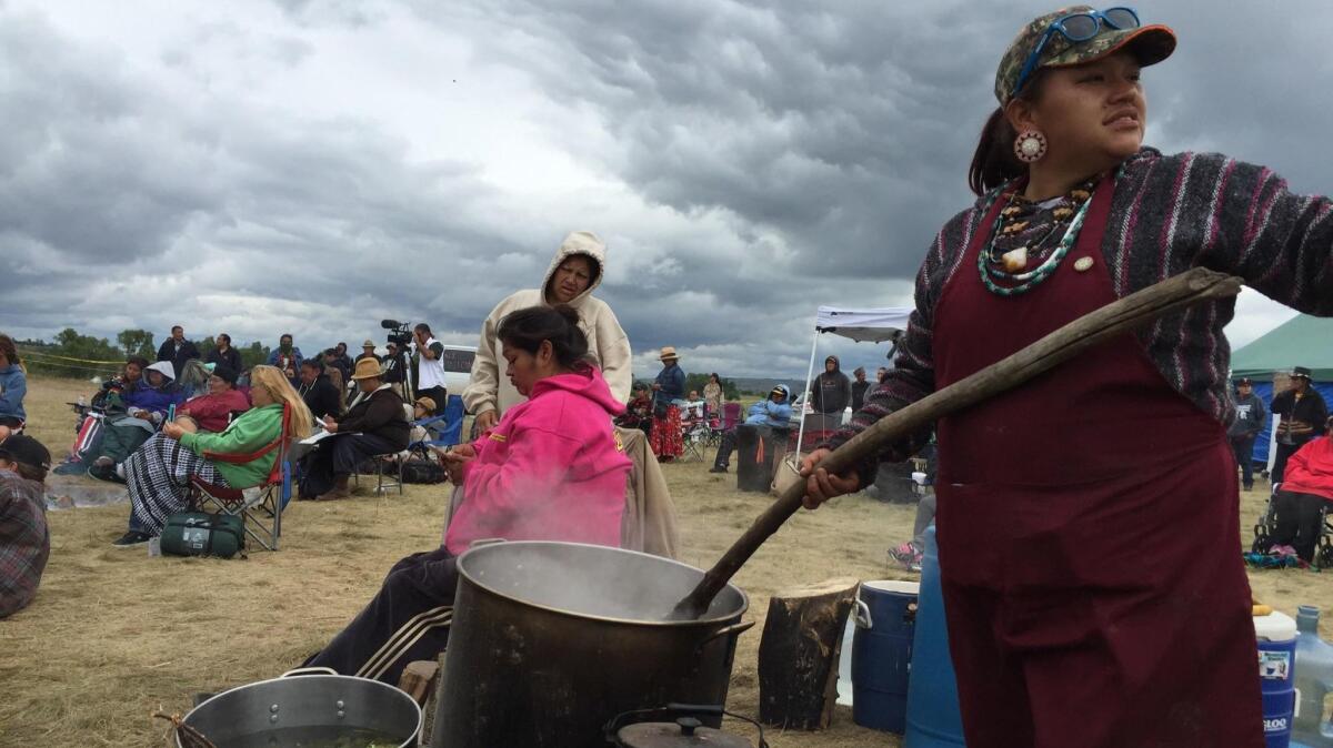 Nantinki Young, known as Tink, stirs soup for protesters gathered along the banks of the Cannonball River.