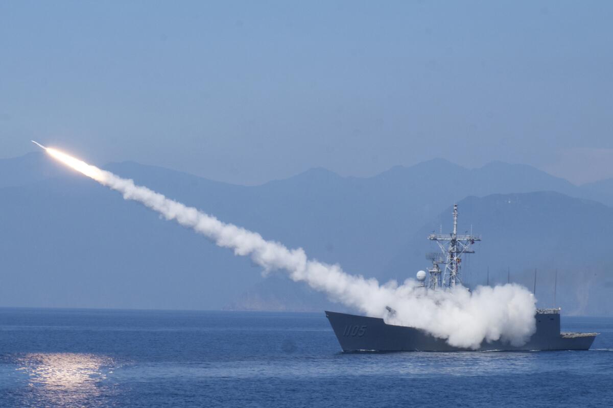 An antiaircraft missile is fired from a boat