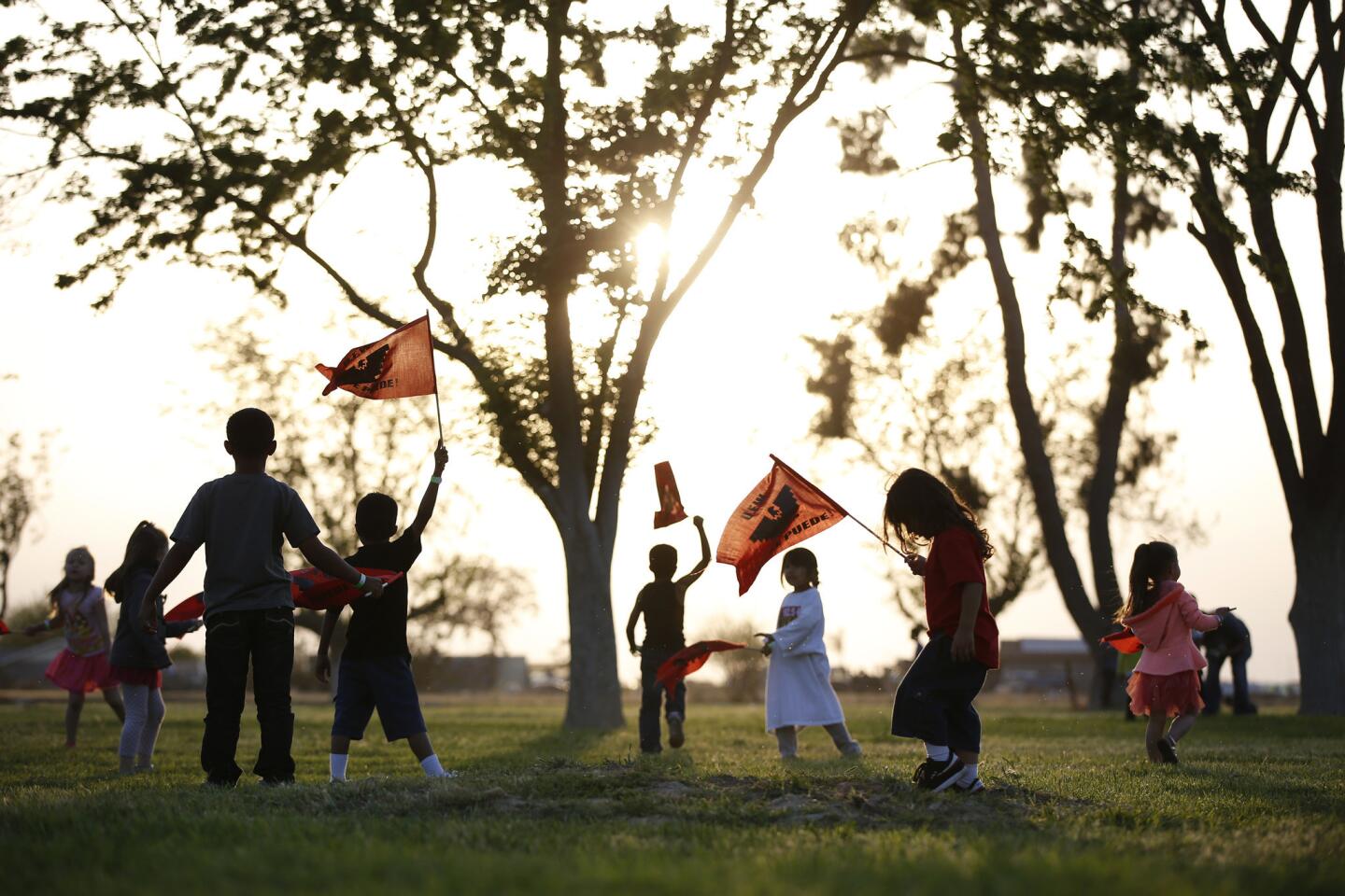 Children play in a field at the 40 Acres, the birthplace of the United Farm Workers union, where hundreds of field workers and family members previewed a special screening of "Cesar Chavez."