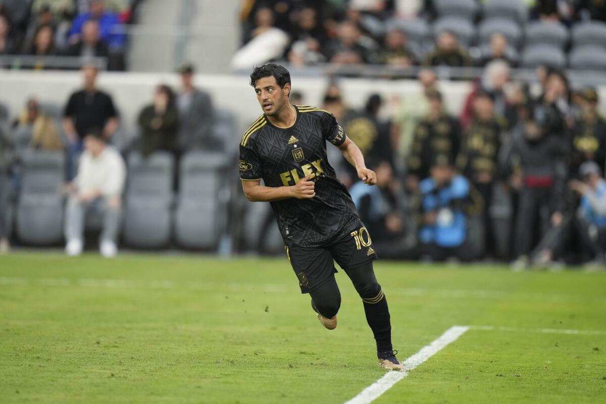 Carlos Vela runs on the field during a game.