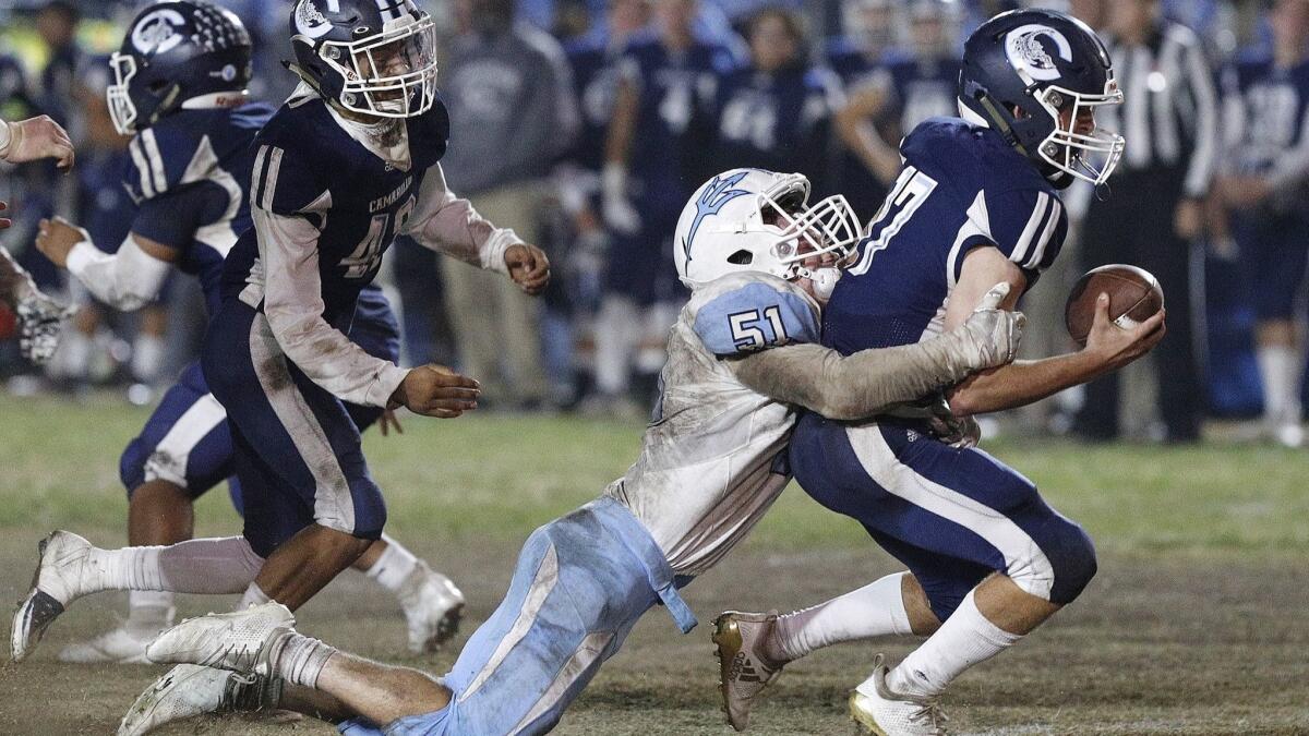 Corona del Mar High's Tristen Troutman sacks Camarillo quarterback James McNamara right before halftime in the semifinals of the CIF Southern Section Division 4 playoffs on Friday.
