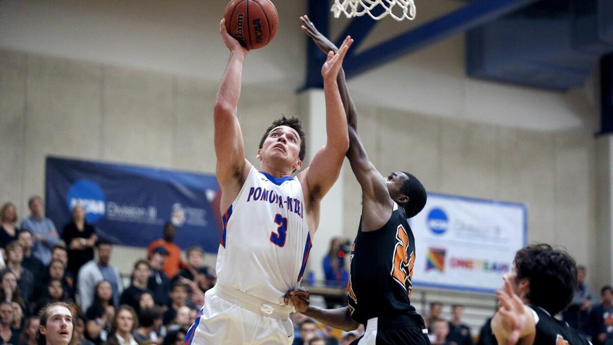 Senior guard Corbin Koch attempts a layup guarded by Occidental's Zach Baines.