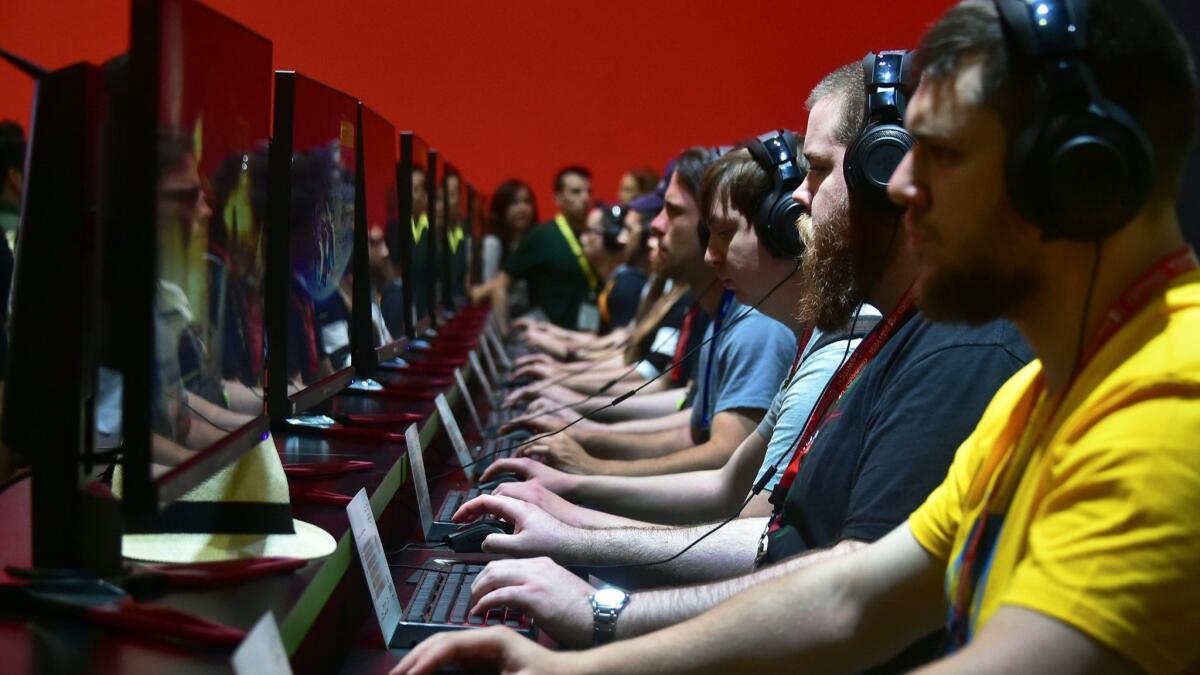 People play "Destiny 2" at the Electronic Entertainment Expo in Los Angeles in 2017. Nvidia gets most of its profit from its GeForce graphics chips, which have been prized by gamers and cryptocurrency miners.