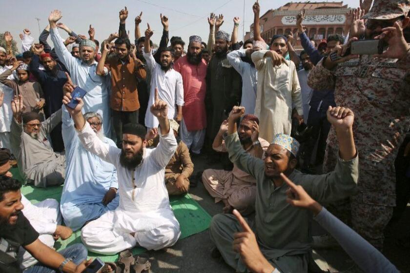 Supporters of a Pakistani religious group chant slogans while block a main road at a protest after a court decision, in Karachi, Pakistan, Wednesday, Oct. 31, 2018. Pakistan's top court has acquitted a Christian woman who has been on death row since 2010 for insulting Islam's Prophet Muhammad. In Wednesday's verdict, the court ordered authorities to free Asia Bibi. (AP Photo/Fareed Khan)